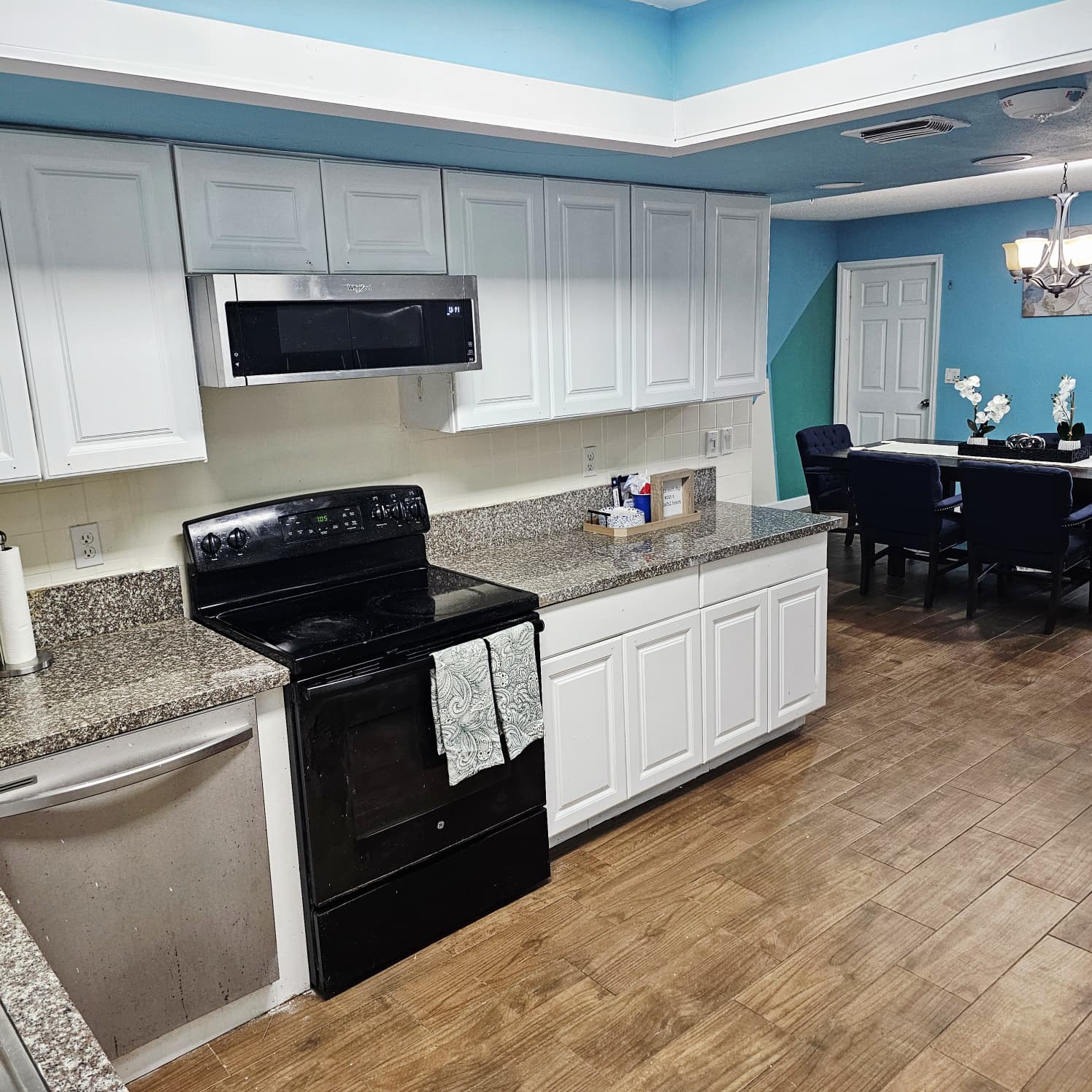 Full kitchen with appliances open to the dining area